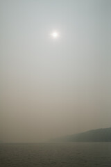 View of the sun, blocked by wildfire smoke, over Puget Sound