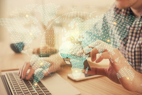 Double exposure of man hands holding a credit card and internet business theme drawing. Digital fintech and E-commerce concept.