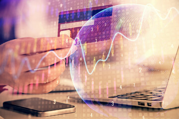 Obraz premium Multi exposure of woman on-line shopping holding a credit card and financial graph drawing. Stock market E-commerce concept.