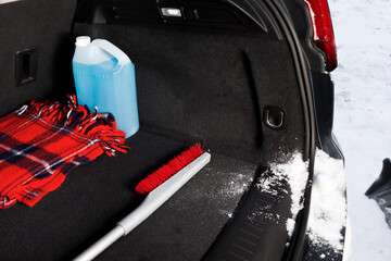 winter driving safety - a snow brush and ice scraper in the trunk