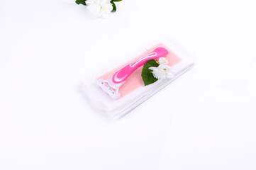 a set of different means for epilation on a colored background. Removal of unwanted hair. Body care products, towels, jasmine flowers, wax strips, razor. Minimalism, top view. flatlay