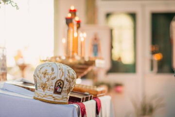 Priest's headdress on the table in the Orthodox Church with an icon