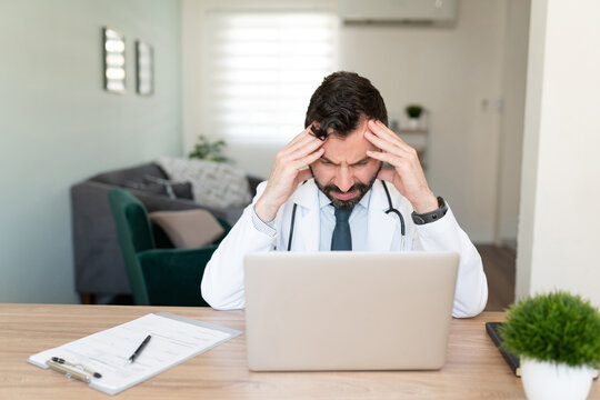 Doctor Working From Home And Looking Stressed