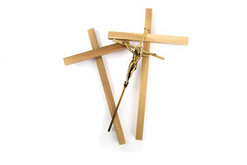 a brass crucifix with two wooden crosses isolated on white