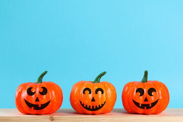 Halloween holiday concept with pumpkin decor on wooden table.