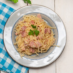 creamy spaghetti pasta with ham on white background