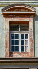 Mazatlan, Mexico - April 23, 2008: Closeup of stone framed window in palace building. chipped and faded paint.