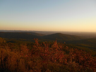 Looking across a colorful mountain valley in the evening one late autumn	