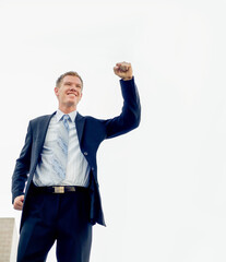 Business man happy smiling with his fist in air.