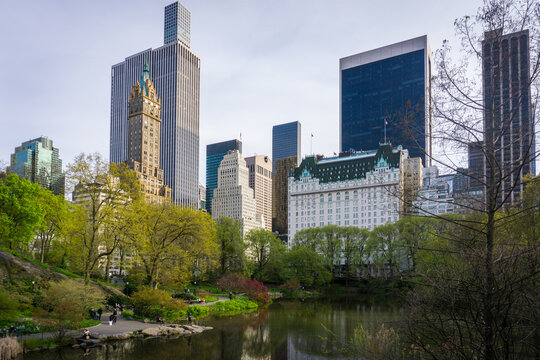 Central Park with a view of trees, lake and Manhattan skyscrapers in the background