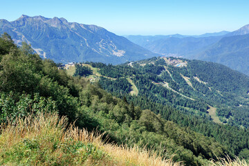 Aerial view of Caucasian mountain range in vicinity of towns of Krasnaya Polyana and Estosadok. Adler District of Sochi, Krasnodar region, Russia.