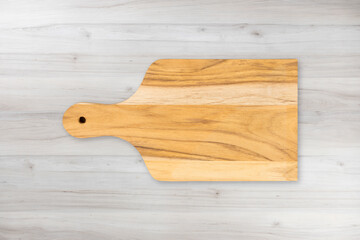 Wooden cutting kitchen Board, isolated on wooden table background. Top view