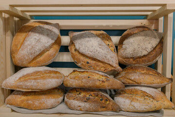 Close-up. Fresh baked goods are beautifully arranged on display in wooden crates. Bread shop