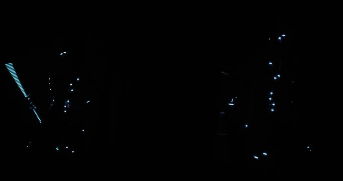 Light performance in the club, two people are dancing and glowing in the dark 4k