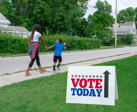 African American Mother And Son Going To Vote Wearing A COVID PPE Face Mask