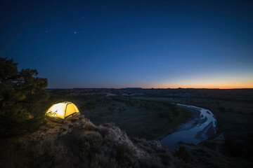 Fototapeta na wymiar Lit up Tent Under the Night Sky