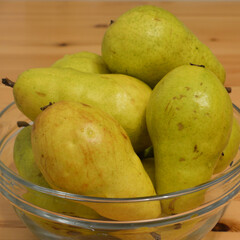 Several ripe pears close up in plate.
