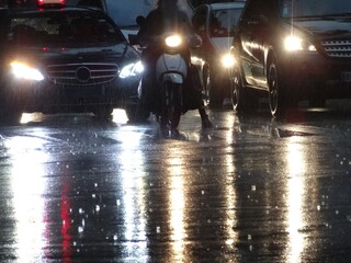 大雨の夜に道路を通行中の車、バイク/A traffic of heavy rainy day at midnight