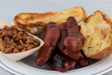 BBQ meal of links, baked beans, and butter toasted bread will taste as delicious as it looks.