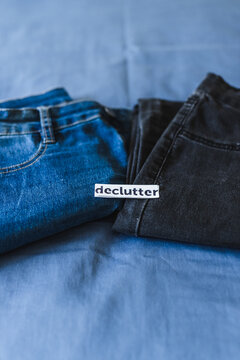 Declutter label on different jeans in various denim colors, tidying up concept