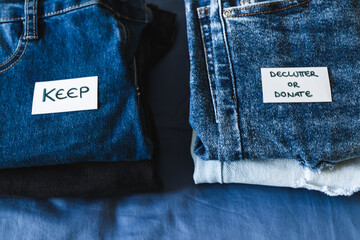 Keep vs Declutter & donate label on different jeans in various denim colors, tidying up concept