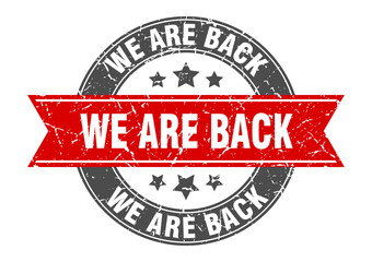Fototapeta premium we are back round stamp with ribbon. label sign