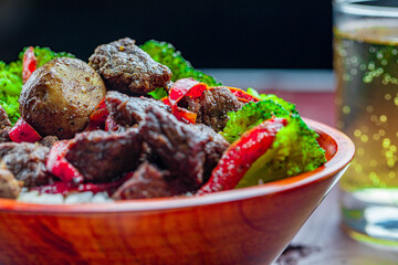 Tasty pepper steak with steamed broccoli and red bell pepper. 