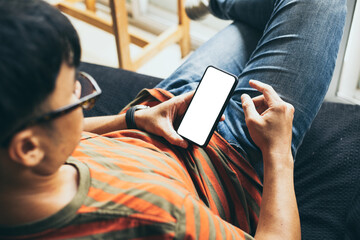 cell phone mockup blank white screen.man hand holding texting using mobile on desk at coffee shop.background empty space for advertise.work people contact marketing business,technology