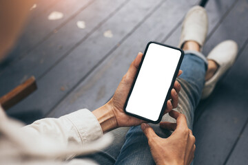 cell phone mockup blank white screen.woman hand holding texting using mobile on desk at coffee shop.background empty space for advertise.work people contact marketing business,technology