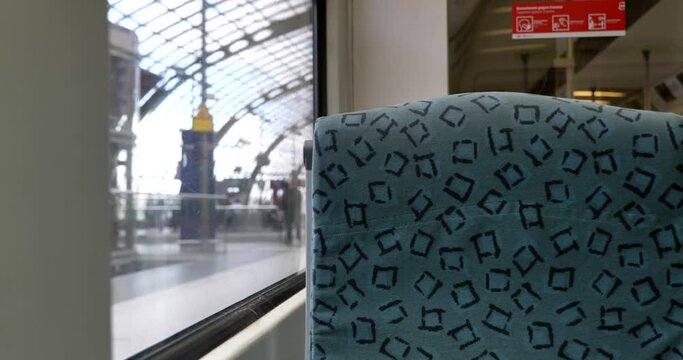 Selected focus at empty interior window seat of train which depart from train station in Berlin, Germany.
