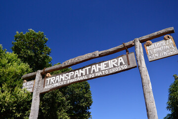 Wooden sign at the beginning of the Transpantaneira road in Pocone, in the middle of the Pantanal,...