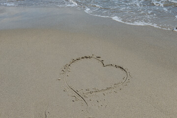 Love on the beach drawn in the sand landscape