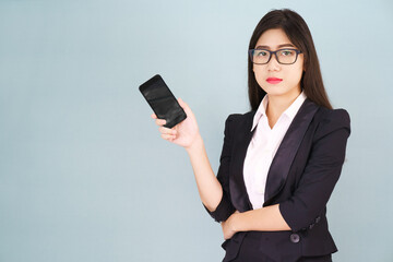 Fototapeta premium Young women in suit holding her smartphone