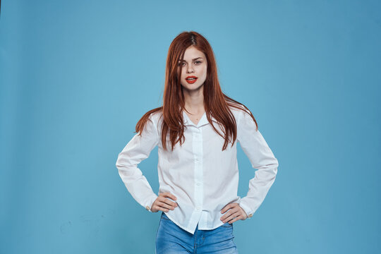 Elegant woman white shirt jeans studio lifestyle blue background