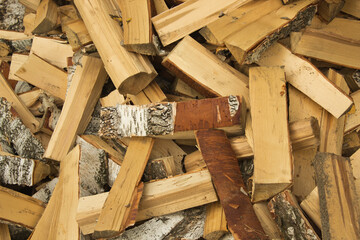 Freshly cut birch firewood. Firewood background. Pile of firewood