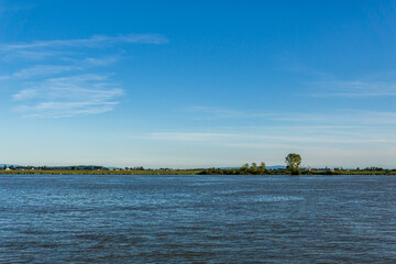 afternoon time at the Fraser River seen from shore at in Richmond British Columbia Canada