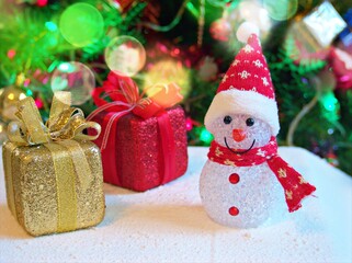 Merry christmas background tree with gifts and decorations for happy new year ,gift box, balls ,snow man, candle for celebration and card design
