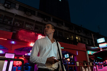 Fototapeta na wymiar Business man listen to music with earphone at night.