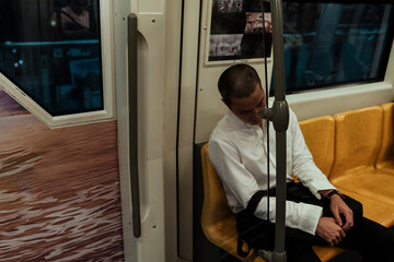 Fototapeta na wymiar Business man sleeping on a train at night.