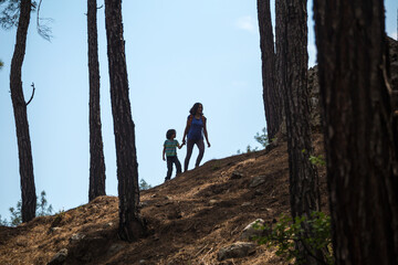 Silhouette of a woman and a child against the sky.