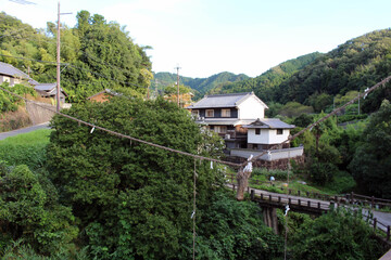 Fototapeta na wymiar Shimenawa rope hanging in the middle of bridge in Asuka, Nara