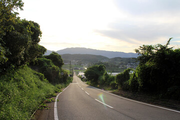 Country road and sunset with mountains as background in Asuka