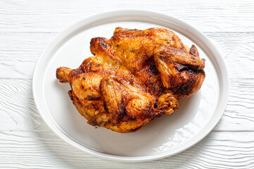 roast chicken served on a white platter