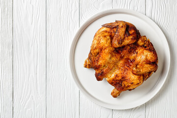 roast chicken served on a white platter