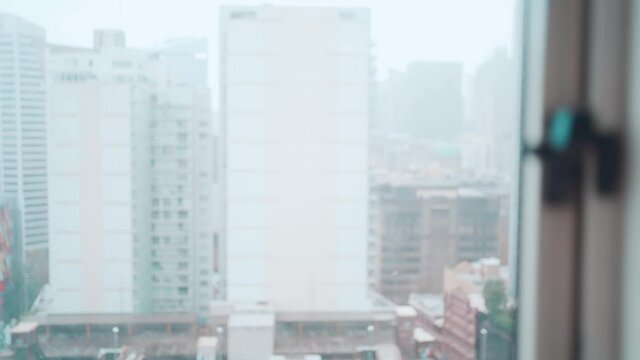 Asian woman looking outside after being locked down. Feeling lonely and homesick, concept stay home
