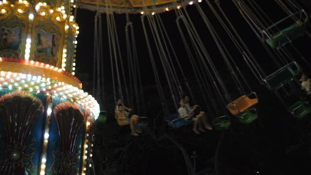 Vietnam, Nha Trang, July 28, 2020.Incredible colorful flashing light of vintage carousel carnival fair merry go round circus horse ride at lights and amusement park, lights in evening amusement park