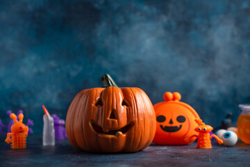 The Halloween's smiling angry pumpkins isolated on dark blue background. Halloween banner. Holiday concept.