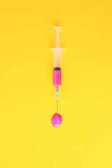 background with pink vaccine on yellow background