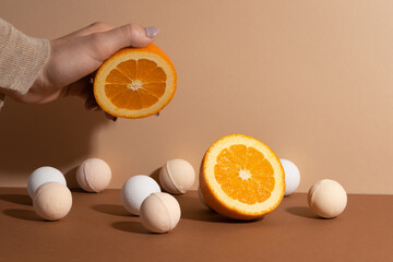 The soft bath bombs witch bright orange isolated on beige background. Flat lay.