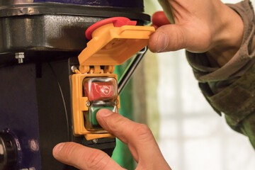 male rude hand presses the green power button